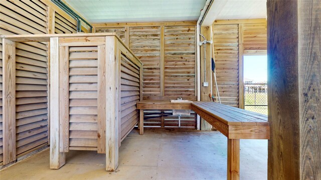 interior space with concrete floors and log walls