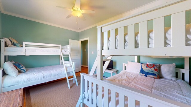 bedroom featuring ceiling fan, hardwood / wood-style flooring, and ornamental molding