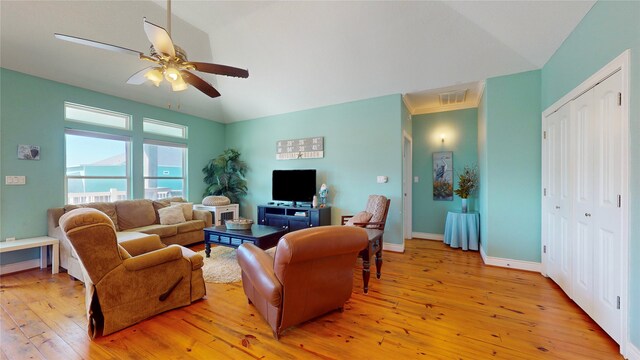 living room featuring light hardwood / wood-style floors and ceiling fan