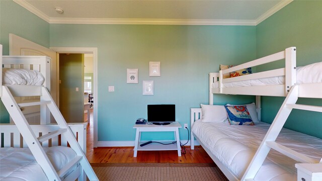 bedroom with wood-type flooring and crown molding