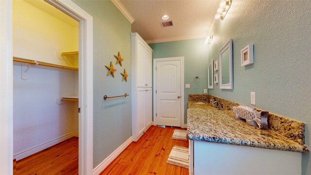 interior space with light hardwood / wood-style floors and crown molding