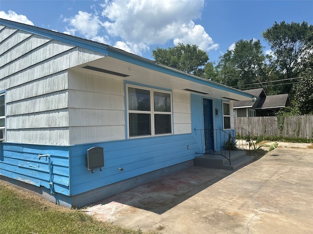 view of property exterior with a patio area