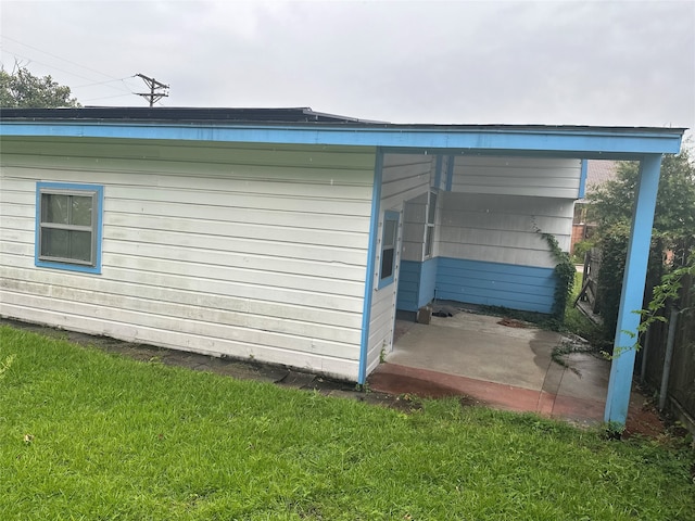 view of outbuilding with a lawn