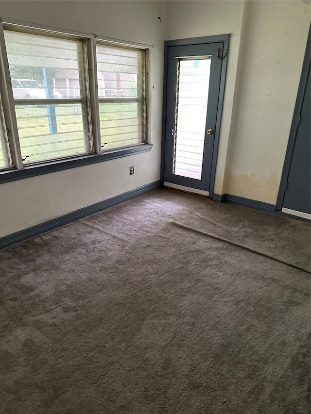 empty room with dark colored carpet