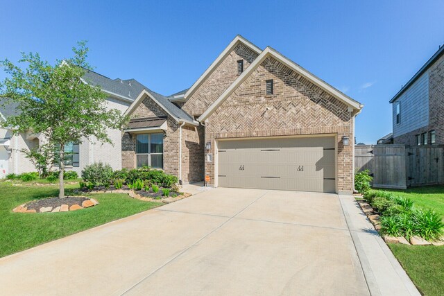 view of front of home with a garage and a front lawn