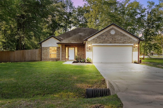 single story home with a garage and a lawn