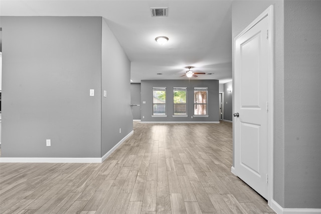 corridor with light wood-type flooring