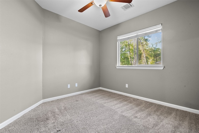 carpeted spare room featuring ceiling fan