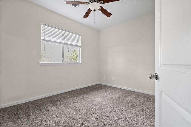 unfurnished room featuring ceiling fan and carpet