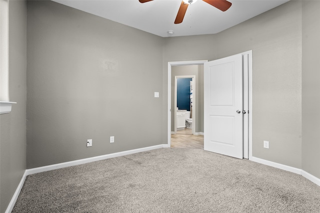 unfurnished bedroom featuring ceiling fan and light carpet