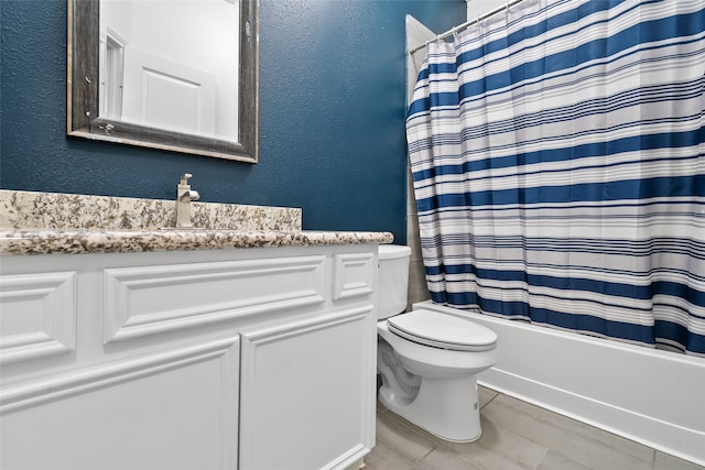 full bathroom featuring toilet, vanity, and shower / bath combination with curtain