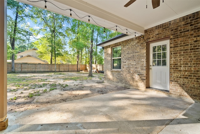 view of yard featuring ceiling fan and a patio area