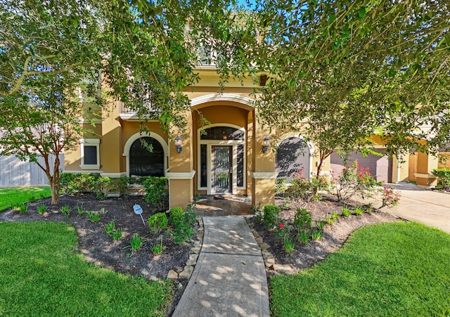 view of front of house with a front yard and a garage