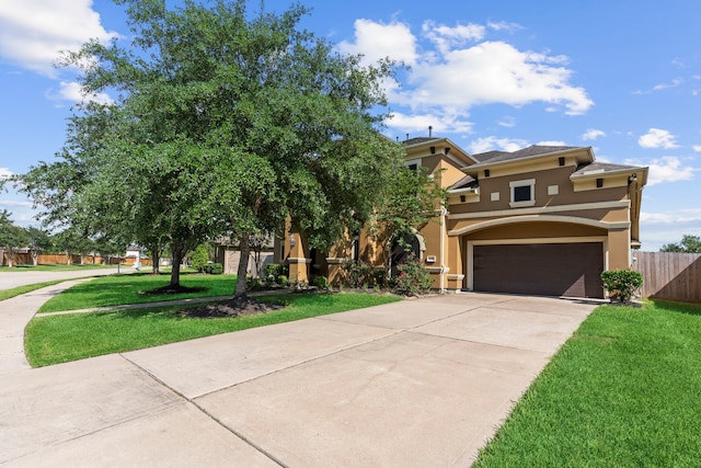 view of front of property featuring a garage and a front yard