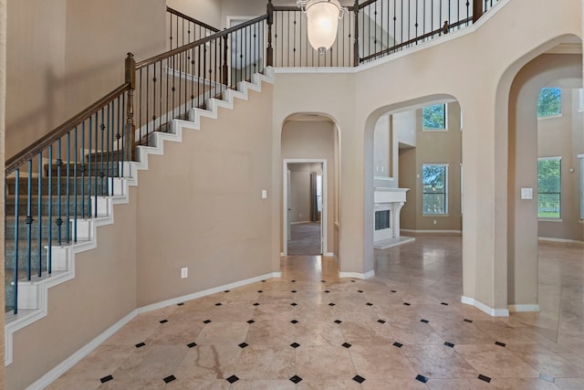 tiled entrance foyer with a towering ceiling