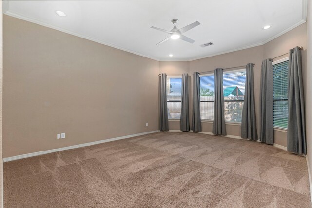 carpeted empty room featuring ceiling fan and crown molding