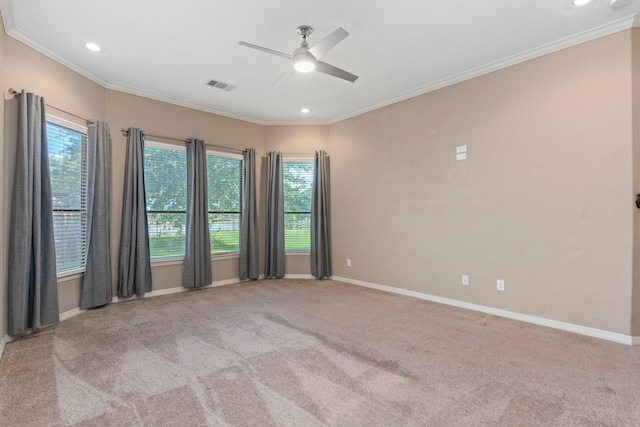 carpeted empty room with ceiling fan and ornamental molding