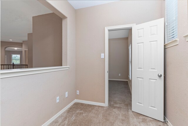 unfurnished room with light colored carpet