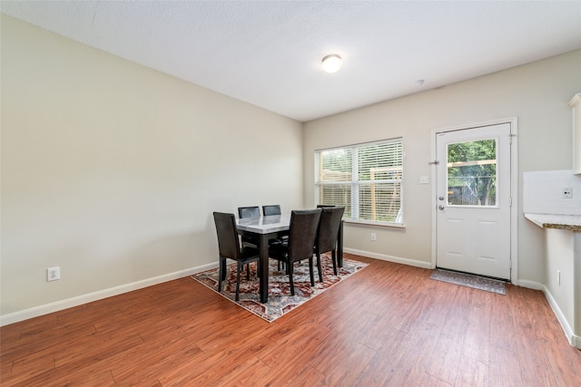 dining space with hardwood / wood-style floors