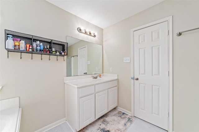 bathroom with oversized vanity, a washtub, and tile flooring