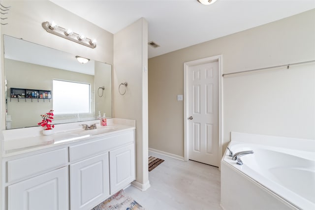 bathroom with a bathing tub and oversized vanity