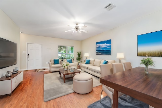 living room featuring hardwood / wood-style floors and ceiling fan