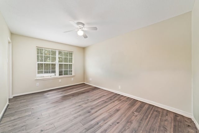 spare room with wood-type flooring and ceiling fan