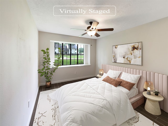 bedroom featuring ceiling fan and a textured ceiling