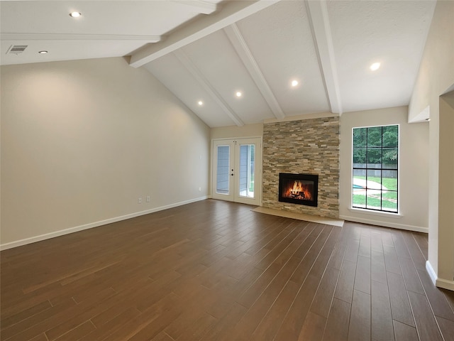 unfurnished living room featuring high vaulted ceiling, beamed ceiling, french doors, dark hardwood / wood-style floors, and a stone fireplace