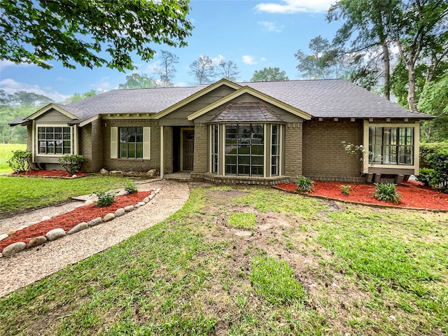 ranch-style home with a front lawn