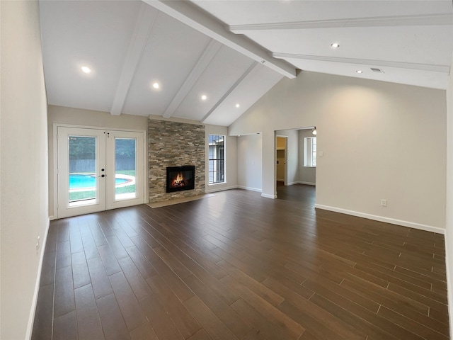 unfurnished living room featuring a stone fireplace, dark wood-type flooring, beam ceiling, and high vaulted ceiling