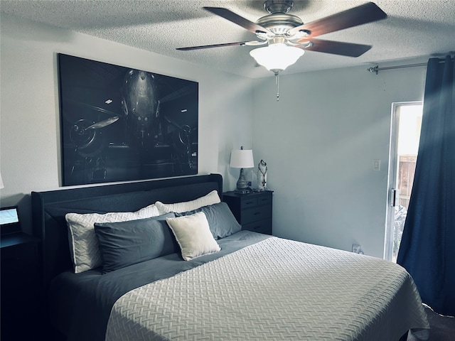 bedroom with ceiling fan and a textured ceiling