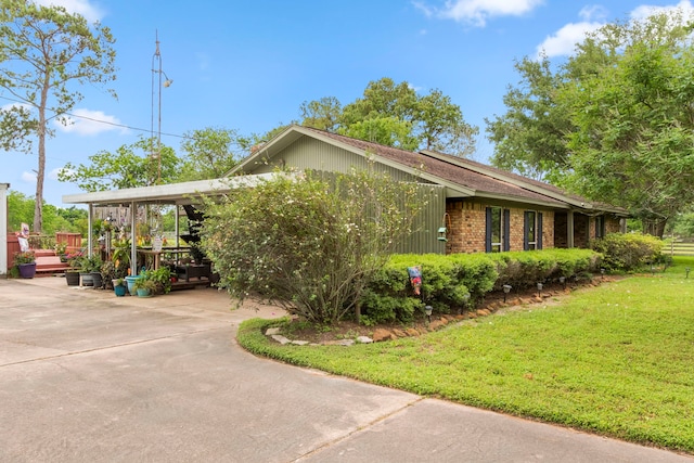 view of side of home featuring a lawn