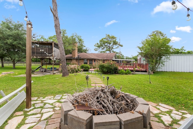 view of patio / terrace featuring an outdoor fire pit and a wooden deck