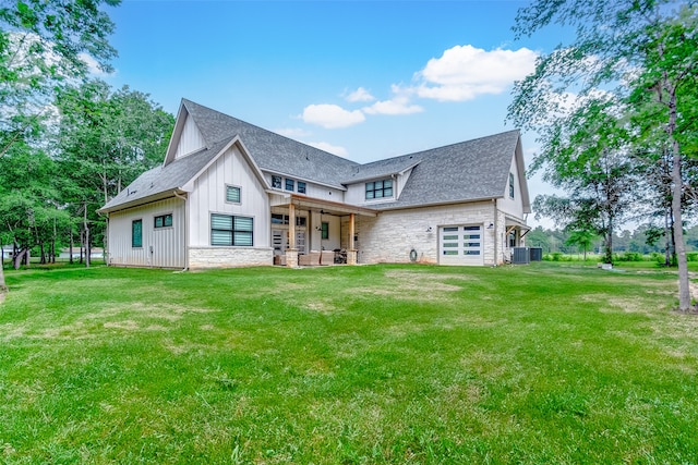 view of front of home featuring a front yard and central AC