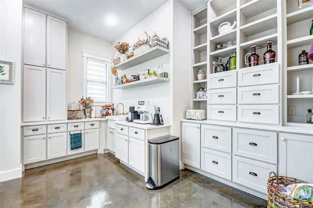 interior space with white cabinets and sink