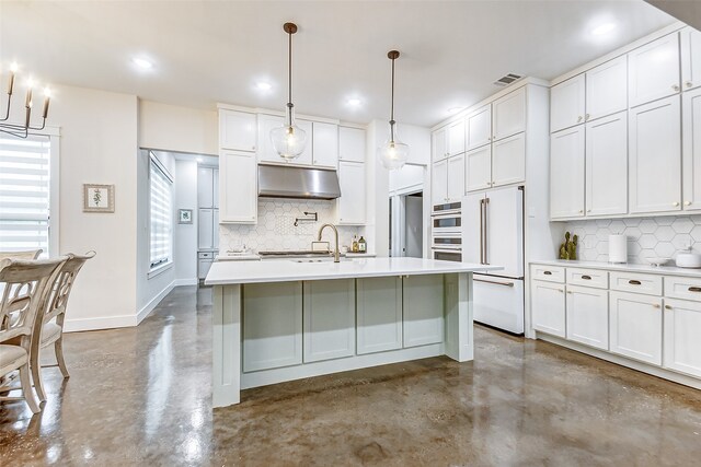 kitchen featuring white cabinets, high end fridge, backsplash, and a kitchen island with sink