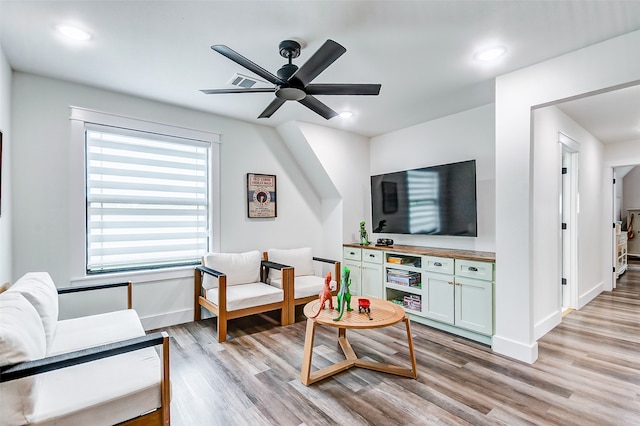 living room featuring ceiling fan and light wood-type flooring