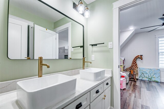 bathroom with double vanity, wood-type flooring, and ceiling fan