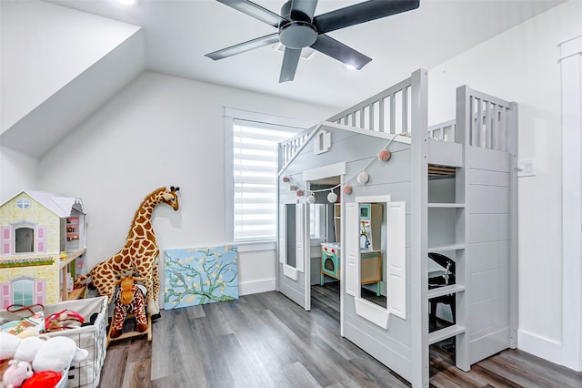 bedroom featuring wood-type flooring, multiple windows, ceiling fan, and vaulted ceiling