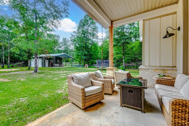 view of terrace featuring a trampoline, an outdoor hangout area, and an outdoor structure