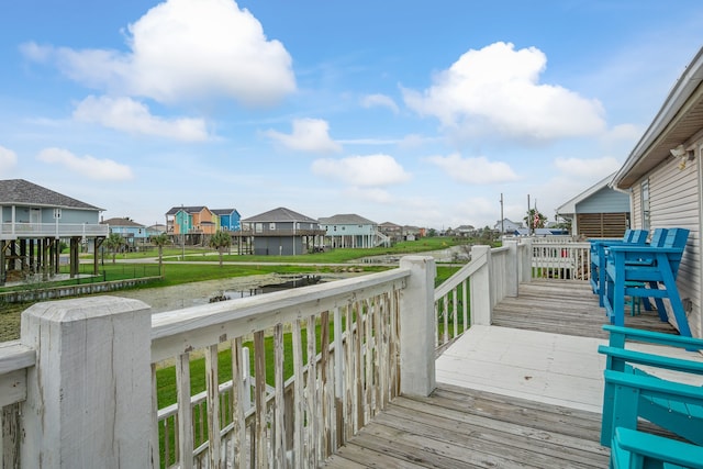 wooden deck with a lawn