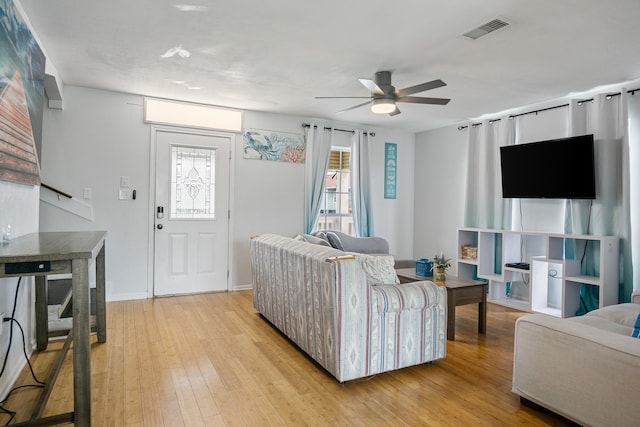 living room with light hardwood / wood-style floors and ceiling fan