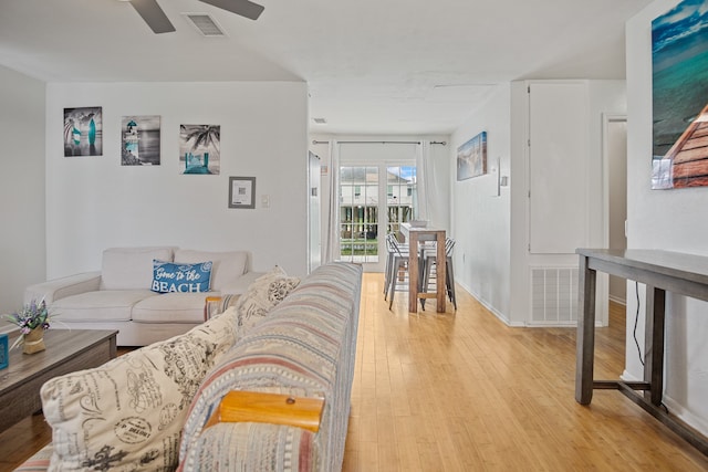 living room featuring light wood-type flooring and ceiling fan