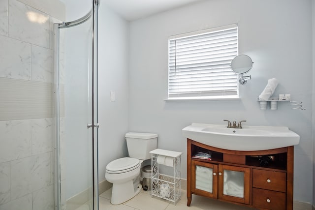 bathroom with vanity, toilet, plenty of natural light, and a shower with door