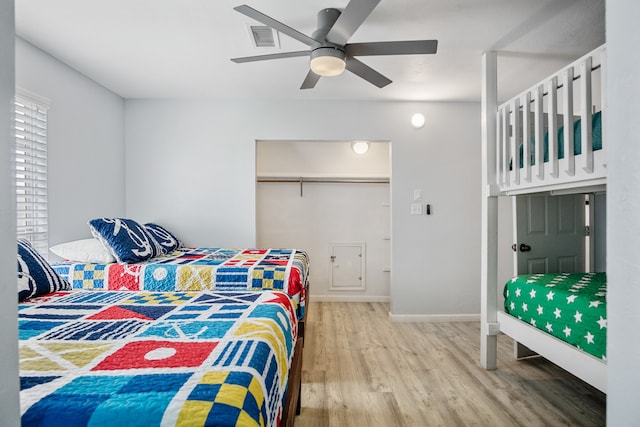 bedroom with wood-type flooring, a closet, and ceiling fan