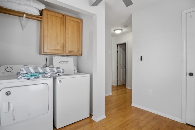 washroom featuring cabinets, light hardwood / wood-style flooring, washing machine and dryer, and ceiling fan