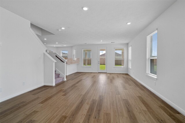 unfurnished living room with wood-type flooring