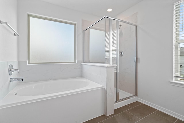 bathroom with tile patterned floors, plenty of natural light, and plus walk in shower