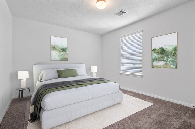 carpeted bedroom with a textured ceiling